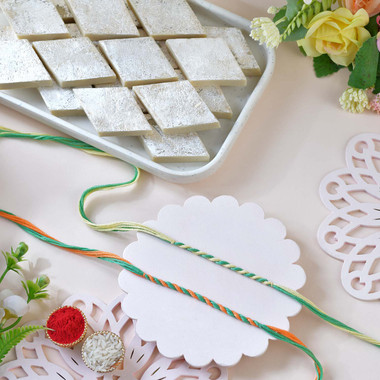 Read more about the article Set of 2 Multicolor Mauli Rakhis with Kaju Katli