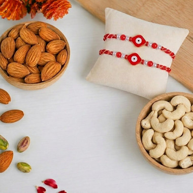 Read more about the article Blue and pink floral design Rakhi With Dry Fruits